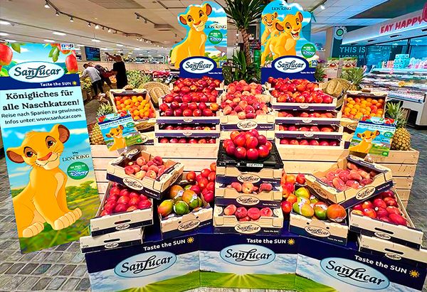 Lionking Colorful SanLucar fruit display in a supermarket featuring a Lion King theme, highlighting apples, pineapples, and fresh produce.
