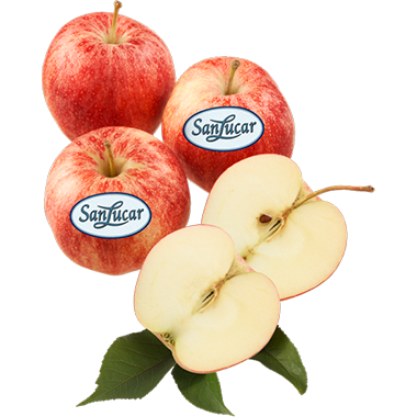 A group of red apples with a SanLucar label, accompanied by a sliced apple revealing its crisp, white interior. Fresh green leaves complete the composition