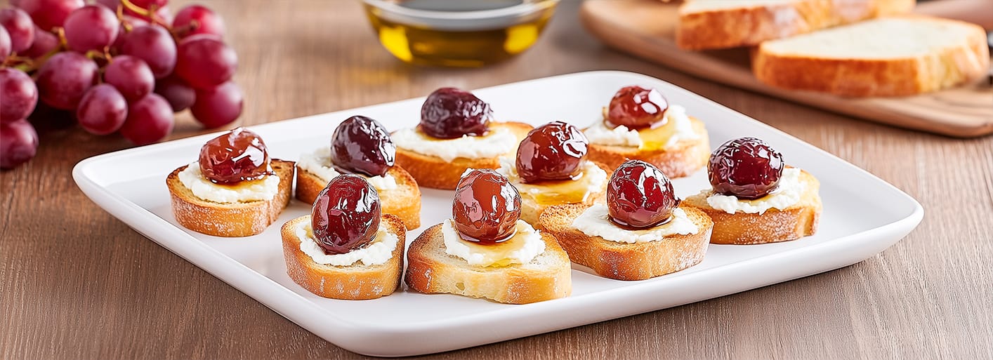 Roasted grape crostini with creamy cheese and herbs – a gourmet appetizer with a sweet and savory twist.