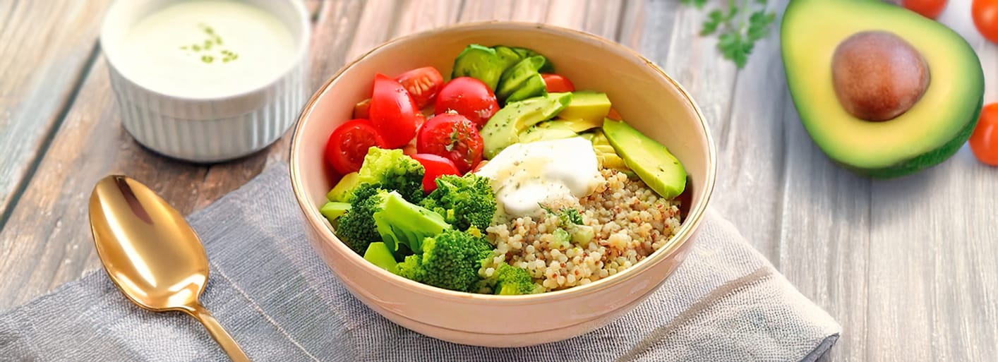 Colorful Quinoa Bowl_header Colorful quinoa bowl with avocado, cherry tomatoes, cucumber, sweet potato, and Tzatziki, served fresh and healthy