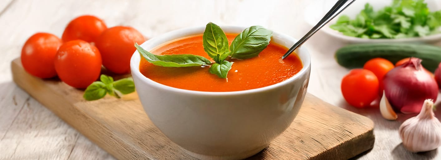 Refreshing gazpacho soup made with fresh tomatoes, cucumbers, and peppers, served chilled and garnished with herbs