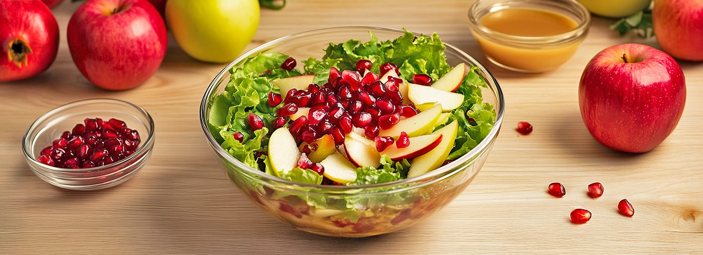 Freshly baked blueberry muffins in brown paper cups, served on a plate with a bowl of blueberries in the background.